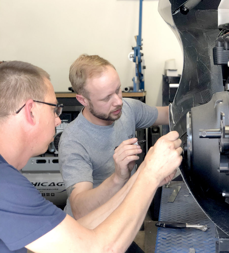 Terry Jackson and Elliott Andrews work on a carbon fibre fairing