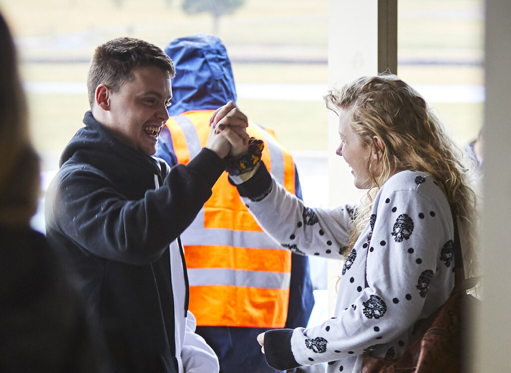 Participants celebrate during the Blind Speed Track Day at Wakefield Park Raceway in Goulburn, Australia, May 2021.